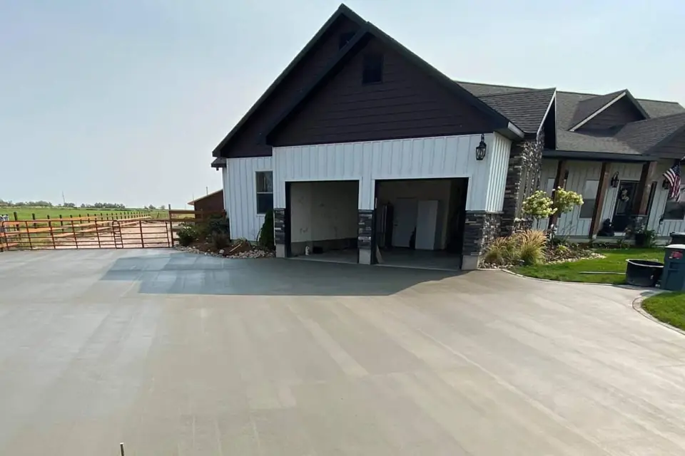 New concrete driveway in front of a newly built home