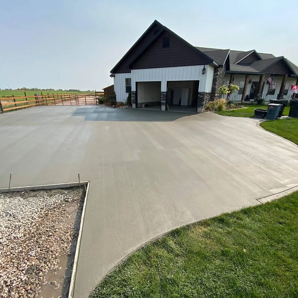 Wide view of the freshly poured concrete driveway and approach