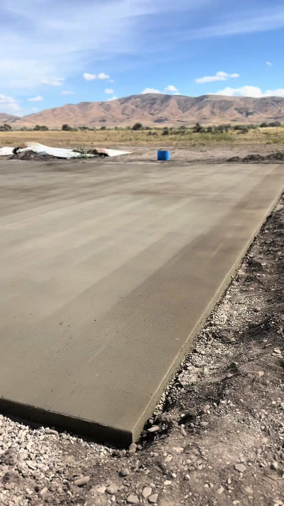 Finished concrete pad and foundation slab in an open landscape